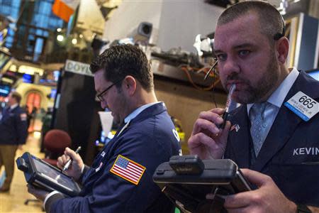 Traders work on the floor of the New York Stock Exchange December 9, 2013. REUTERS/Brendan McDermid