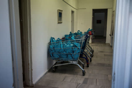 Shopping carts full of plastic bags containing food supplies for impoverished Greeks are seen at an Athens Municipality-run centre in Athens, Greece, February 17, 2017. REUTERS/Alkis Konstantinidis