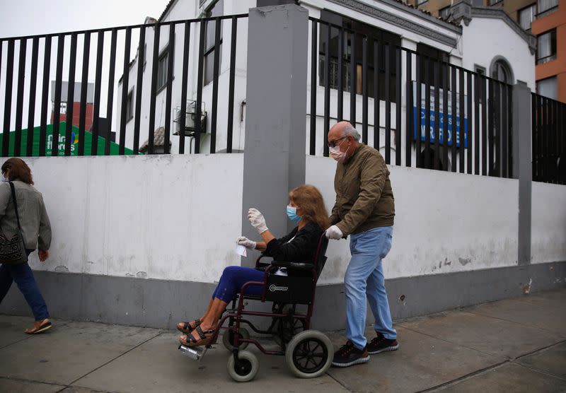 An eldery patient is brought into a health center after the Peruvian government closed the country's borders in response to the outbreak of coronavirus disease (COVID-19), in Lima