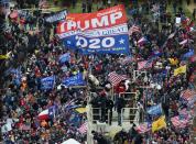 Supporters of US President Donald Trump take over stands set up for the presidential inauguration as they protest at the US Capitol in Washington, DC, January 6, 2021. - Demonstrators breeched security and entered the Capitol as Congress debated the a 2020 presidential election Electoral Vote Certification. (Photo by Olivier DOULIERY / AFP) (Photo by OLIVIER DOULIERY/AFP via Getty Images)