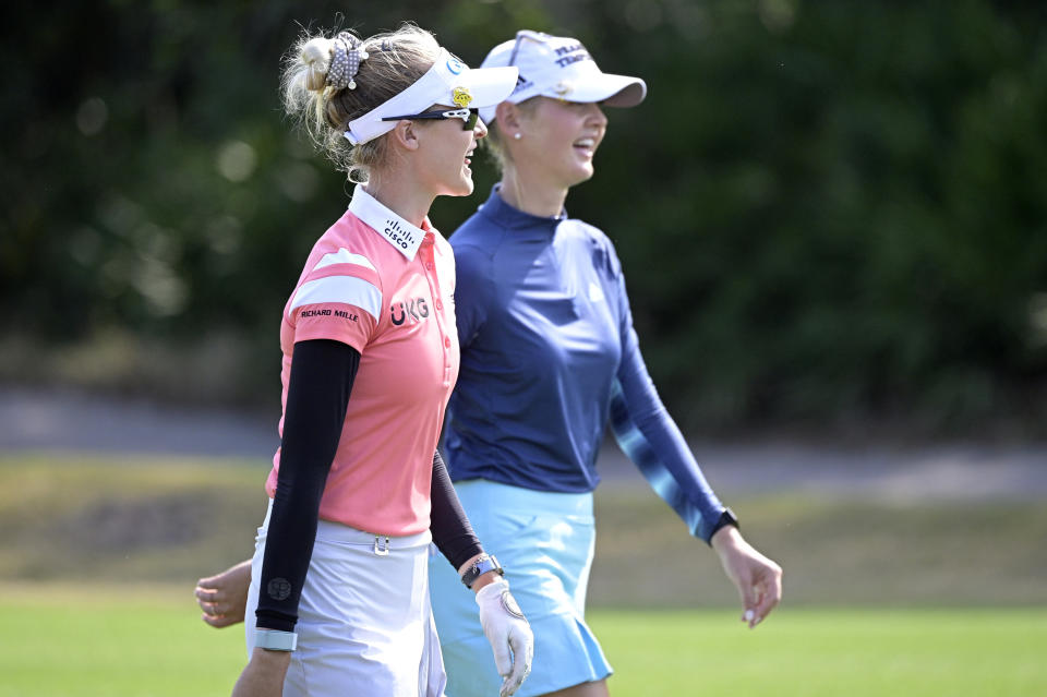 Nelly Korda, left, and her sister Jessica Korda share a laugh while walking together on the seventh fairway during the final round of the Tournament of Champions LPGA golf tournament, Sunday, Jan. 24, 2021, in Lake Buena Vista, Fla. (AP Photo/Phelan M. Ebenhack)