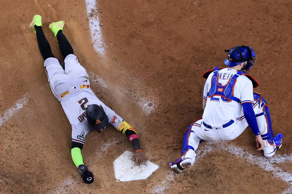 Geraldo Perdomo slides in a run during Arizona's 9-1 rout on Saturday. (Carmen Mandato/Getty Images)