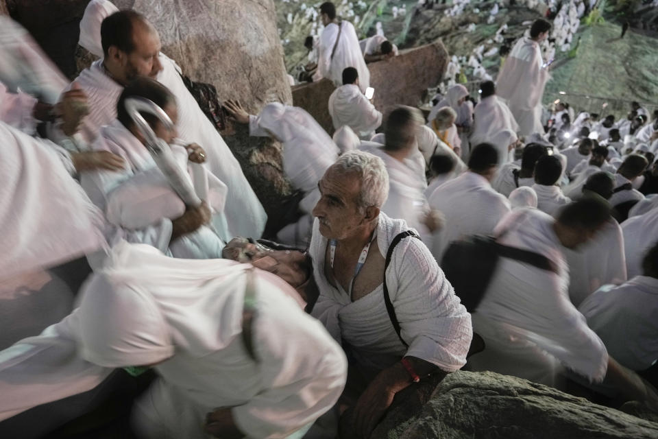 Muslim pilgrims ascend the rocky hill known as the Mountain of Mercy, on the Plain of Arafat, during the annual Hajj pilgrimage, near the holy city of Mecca, Saudi Arabia, Tuesday, June 27, 2023. Around two million pilgrims are converging on Saudi Arabia's holy city of Mecca for the largest Hajj since the coronavirus pandemic severely curtailed access to one of Islam's five pillars. (AP Photo/Amr Nabil)