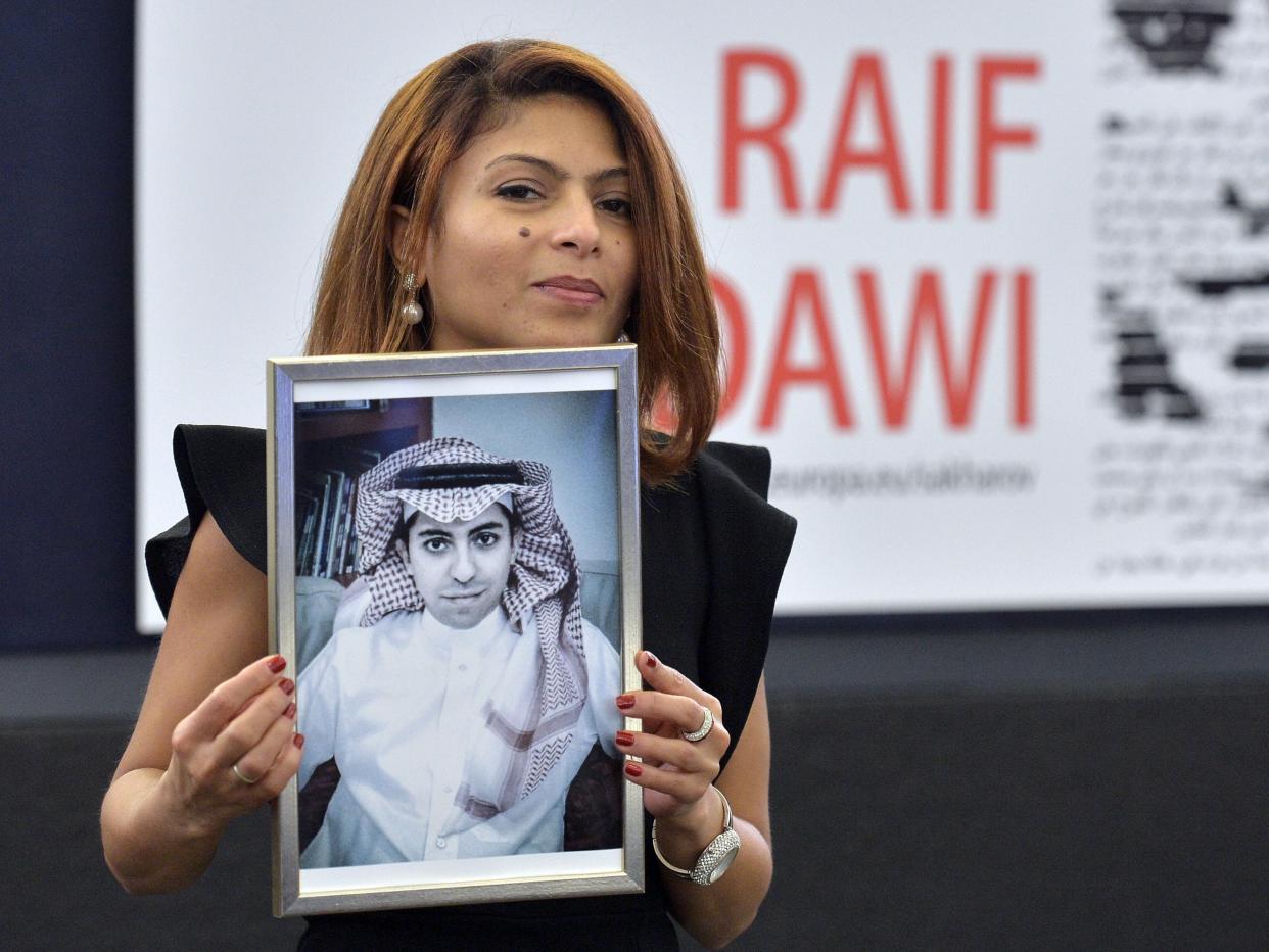 Ensaf Haidar holds a picture of her husband Raif Badawi