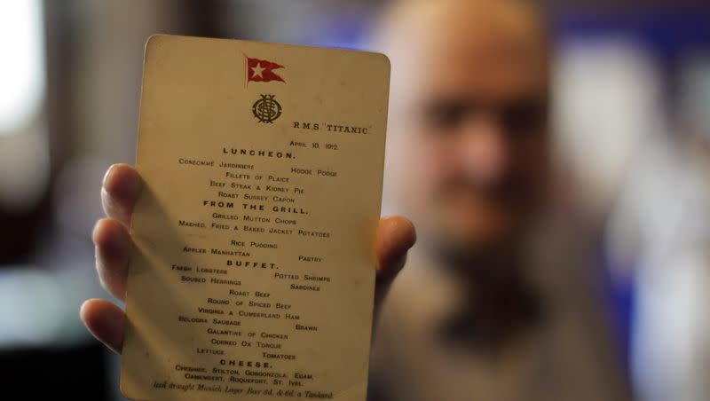 A member of staff from the auction house Aldridge and Son holds an original Titanic menu from April 10, 1912, during a unique exhibition relating to the ill-fated liner on display at Belfast City Hall, Northern Ireland, in 2012.