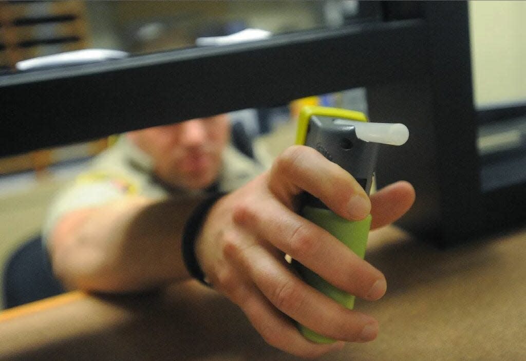 An officer gets ready to administer a breathalyzer test at the Minnehaha County Building in 2016. Tests are given twice a day to those in the 24/7 Sobriety program.