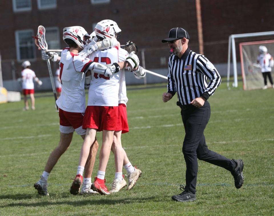 Spaulding's Jayden Peverada and teammates celebrate after he scored a goal in the first quarter against Hollis-Brookline last Wednesday.