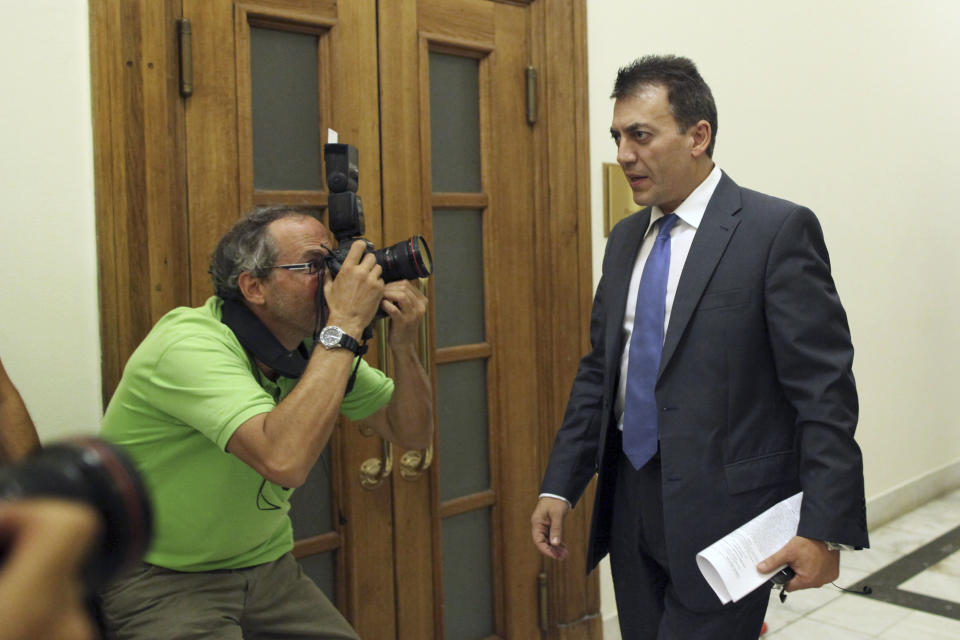 Greek Labor Minister Yiannis Droutsis, right, enters Prime Minister Antonis Samaras' office inside the Greek Parliament, in Athens, Tuesday, Oct. 16, 2012. Greece has been surviving on emergency loans from eurozone countries and the International Monetary Fund for more than two years. It is currently locked in protracted negotiations with rescue creditors for a major new austerity package that is set to take the country into a sixth year of recession in 2013. (AP Photo/Petros Giannakouris)