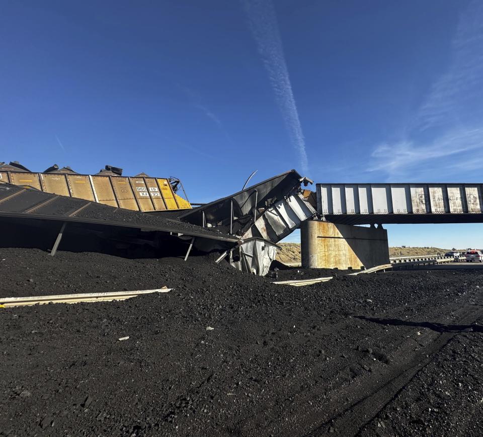 In this photo released by the Pueblo County Sheriff's Office, the wreckage of a train derailment is pictured near Pueblo, Colo., Sunday, Oct. 15, 2023. The train derailment Sunday spewed coal and mangled train cars across the highway. (Joshua Johnson/Pueblo County Sheriff's Office via AP)