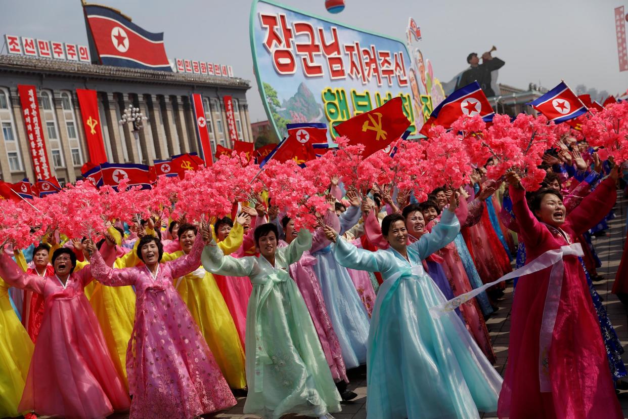 Women wearing traditional clothes react as they march past the stand with North Korean leader Kim Jong-un during a military parade marking the 105th birth anniversary of the country's founding father, Kim Il-sung in Pyongyang: Damir Sagolj/Reuters