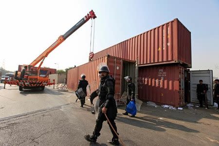 A Frontier Constabulary (FC) personnel walks past a container, which will be used to block roads during a planned protest called by political party Pakistan Tehreek-e-Insaf (PTI) in Islamabad, Pakistan, October 31, 2016. REUTERS/Faisal Mahmood