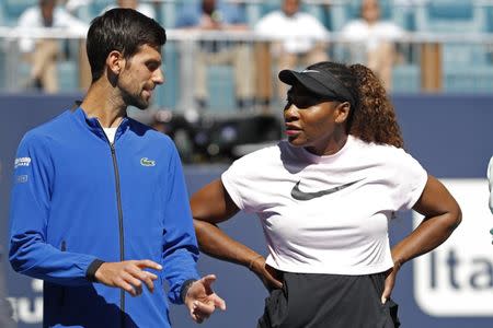 Mar 20, 2019; Miami Gardens, FL, USA; Novak Djokovic of Serbia (L) speaks to Serena Williams of the United States (R) during a ribbon cutting ceremony on new stadium court at Hard Rock Stadium prior to play in the first round of the Miami Open at Miami Open Tennis Complex. Geoff Burke