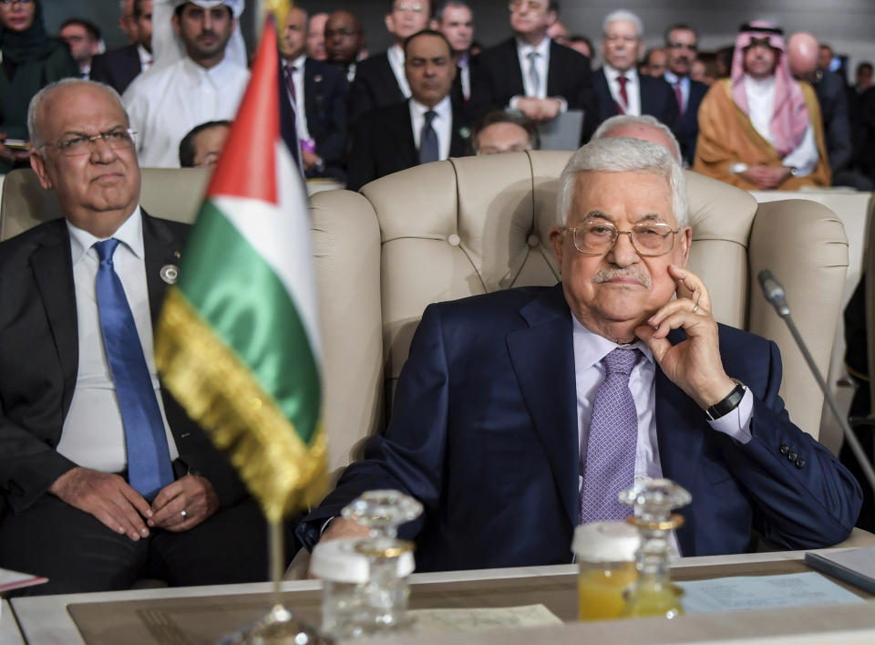 FILE - In this March 31, 2019 file photo, Palestinian President Mahmoud Abbas, right, and Secretary General of the Palestinian Liberation Organization Saeb Erekat, attend the 30th Arab Summit in Tunis, Tunisia. Erekat, a veteran peace negotiator and prominent international spokesman for the Palestinians for more than three decades, died Tuesday, Nov. 10, 2020. He was 65. (Fethi Belaid/ Pool photo via AP, FIle)