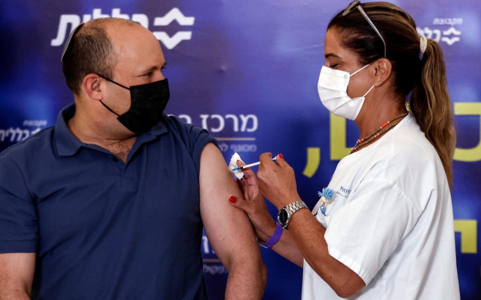 Israeli Prime Minister Naftali Bennett receives a third shot of the Covid-19 vaccine in Kfar Saba - RONEN ZVULUN/REUTERS