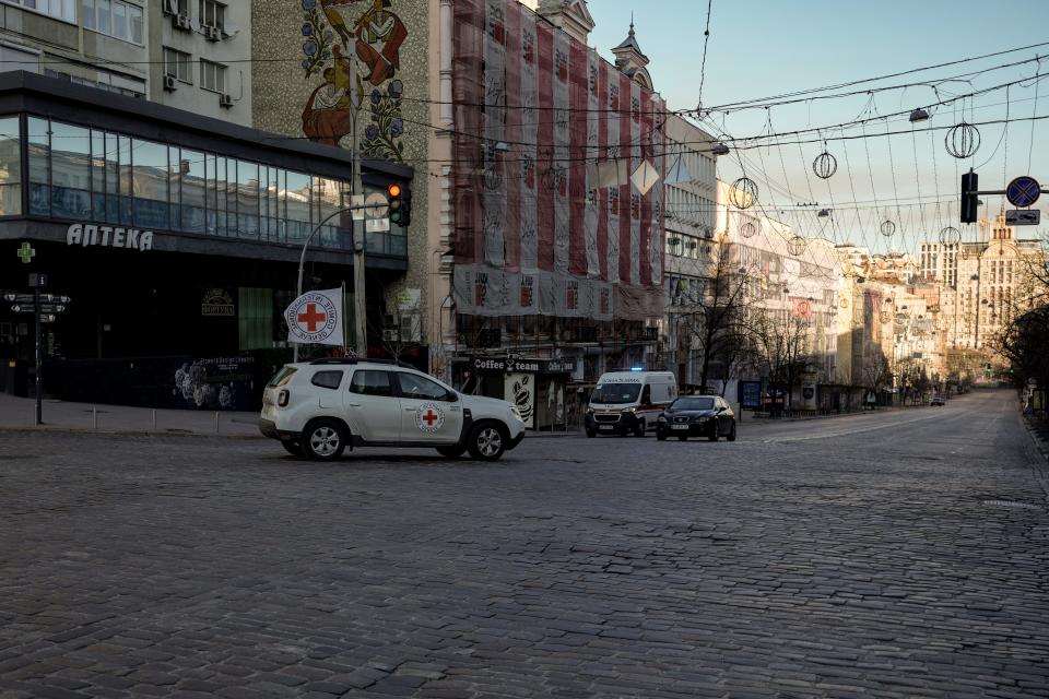 An International Committee of the Red Cross vehicle drives on a deserted boulevard in downtown Kyiv, Ukraine, on Wednesday. Moscow's forces rained fire on Kyiv and other major cities in a bid to crush the resistance that has frustrated Kremlin hopes for a lightning victory.