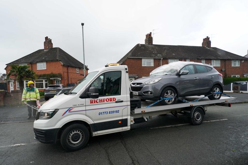 A damaged vehicle is towed away from St Gile's Road in Knutton, North Staffordshire (PA)