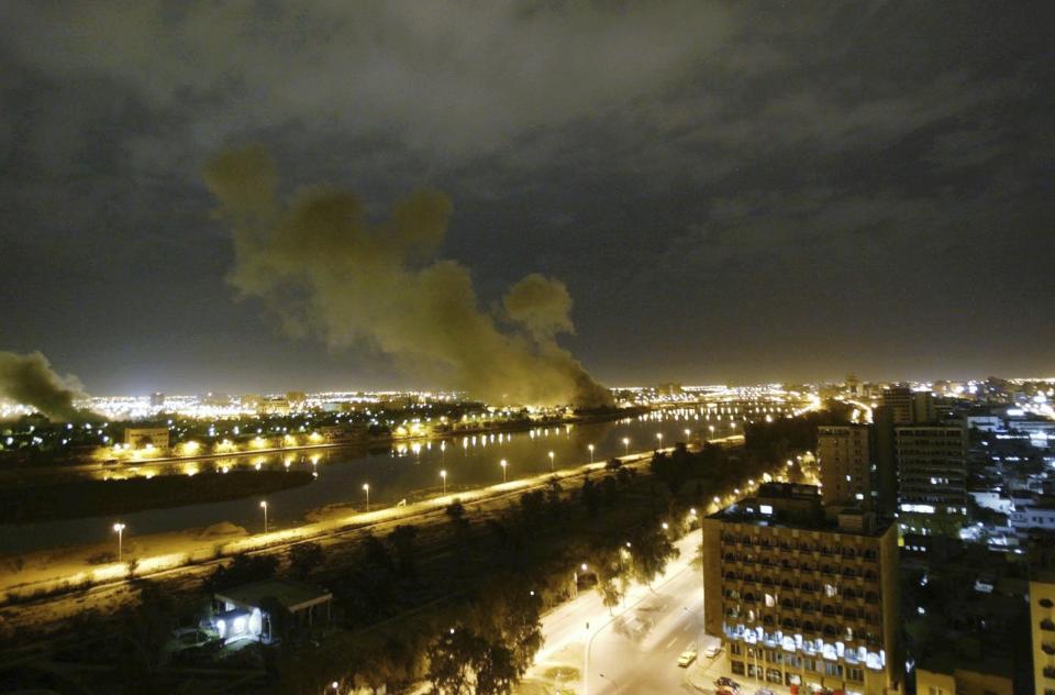 FILE - Smoke rises from the Trade Ministry in Baghdad on March 20, 2003, after it was hit by a missile during US-led attacks. (AP Photo/Jerome Delay, File)