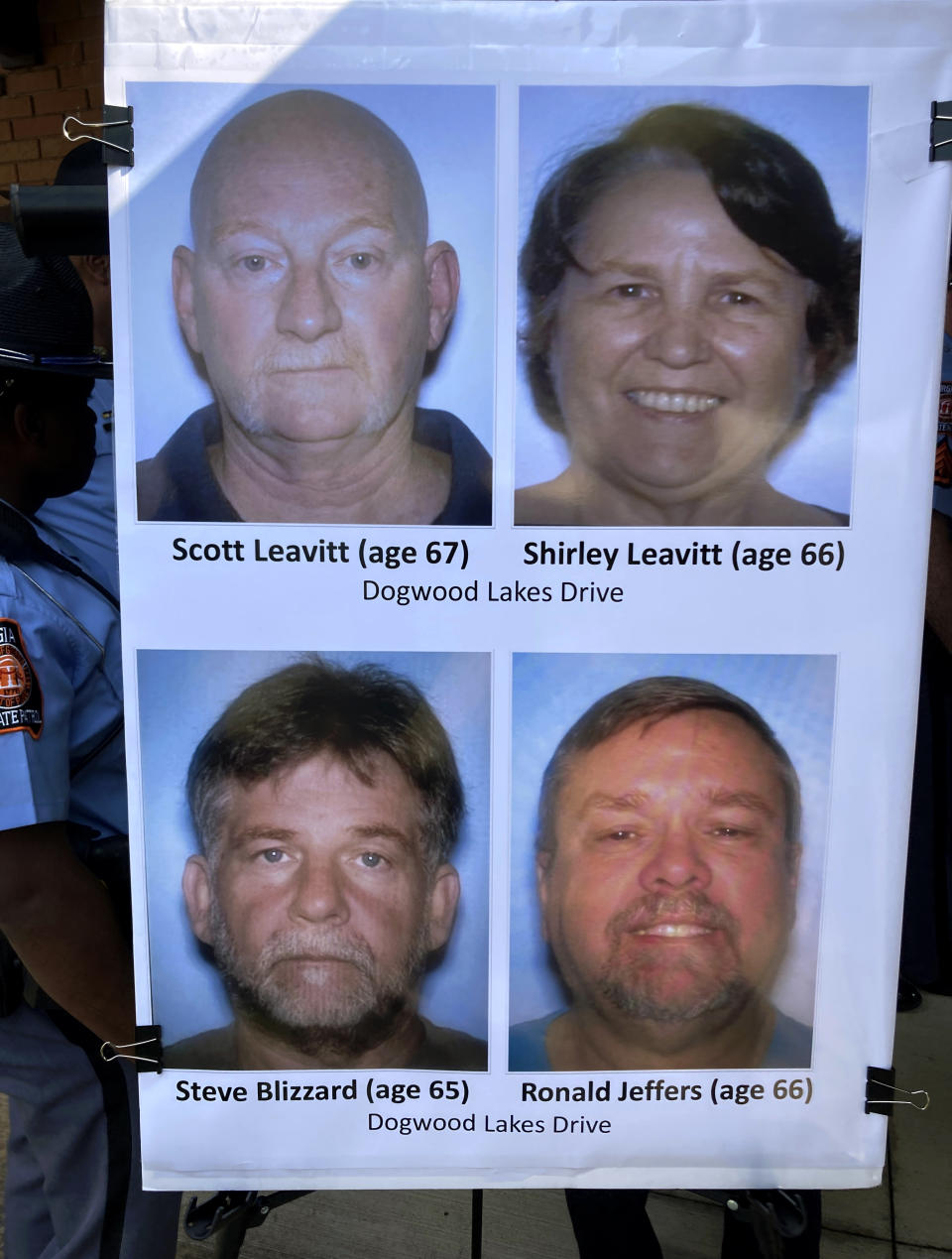 Pictures identifying the four people shot and killed in Saturday's shooting near Atlanta are displayed by officers, Sunday, July 16, 2023, in Hampton, Ga. (AP Photo/Jeff Amy)