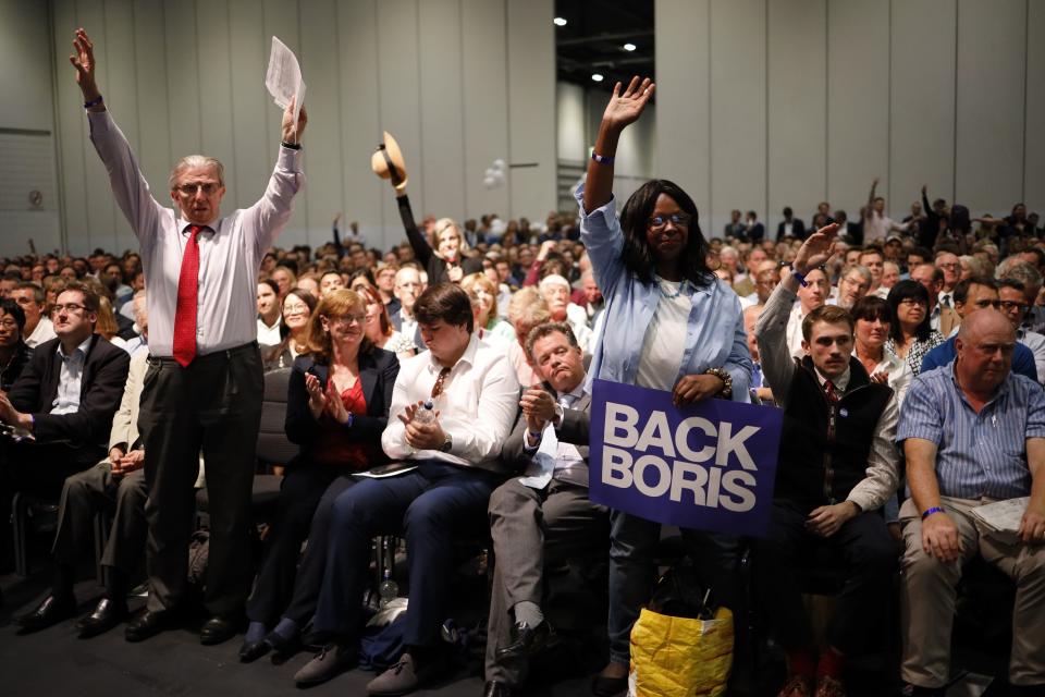 Supporters hold placards as Conservative MP and leadership contender Boris Johnson speaks at the final Conservative Party leadership election hustings in London, on July 17, 2019. - The battle to become Britain's next prime minister enters the home straight on Wednesday with both candidates hardening their positions on Brexit, putting the future government on a collision course with Brussels. (Photo by Tolga Akmen / AFP)        (Photo credit should read TOLGA AKMEN/AFP/Getty Images)