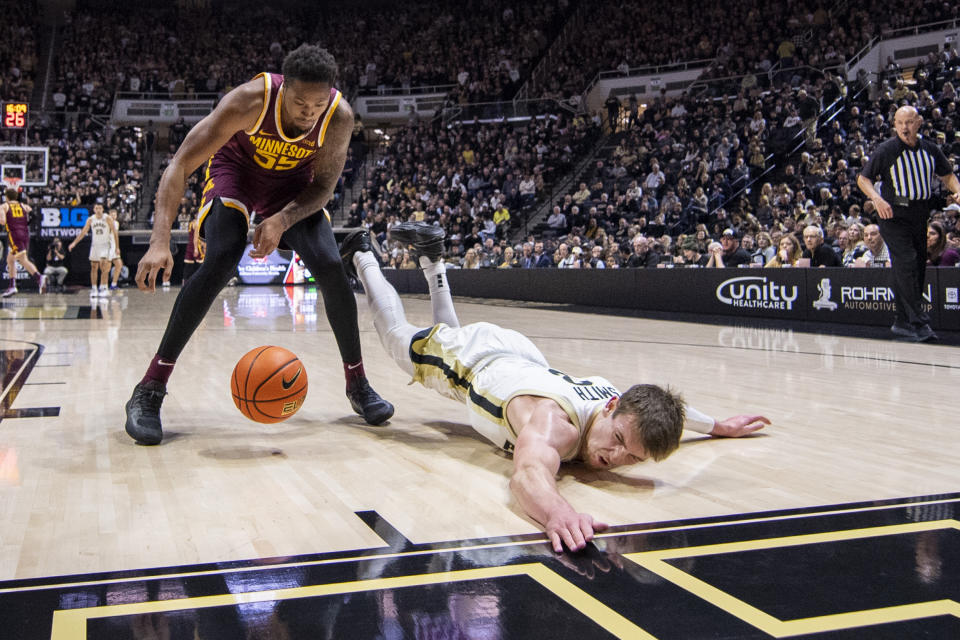 Purdue guard Braden Smith, right, slides out-of-bounds while attempting to steal the ball away from Minnesota guard Ta'lon Cooper during the second half of an NCAA college basketball game, Sunday, Dec. 4, 2022, in West Lafayette, Ind. (AP Photo/Doug McSchooler)