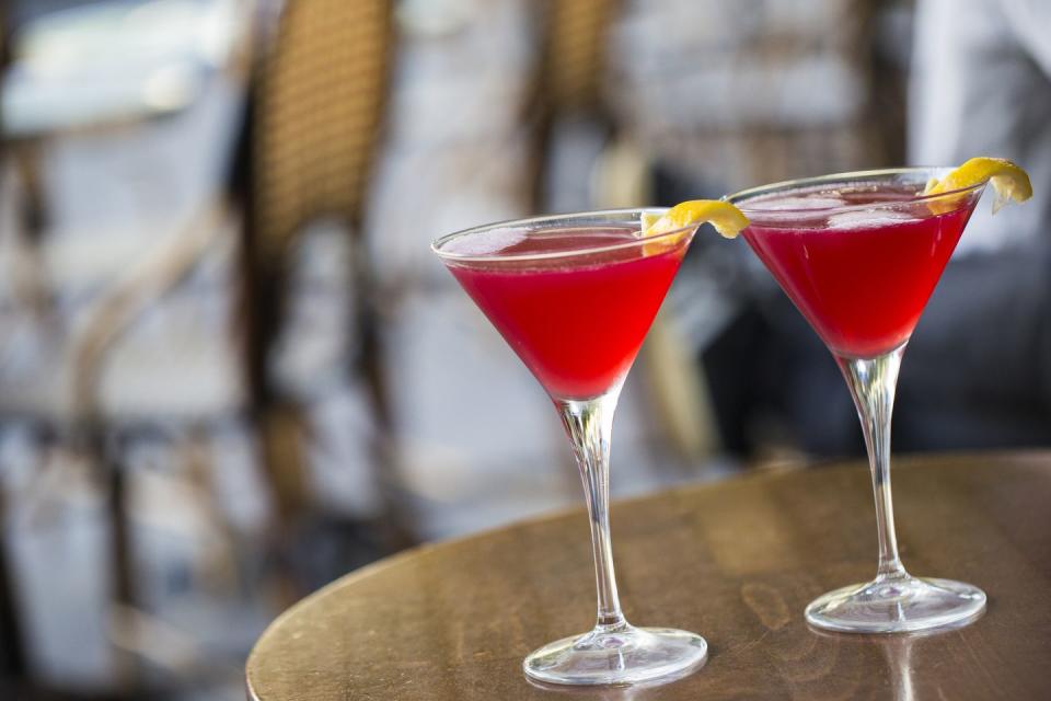 close up of two cosmopolitan martinis on a paris sidewalk bar patio