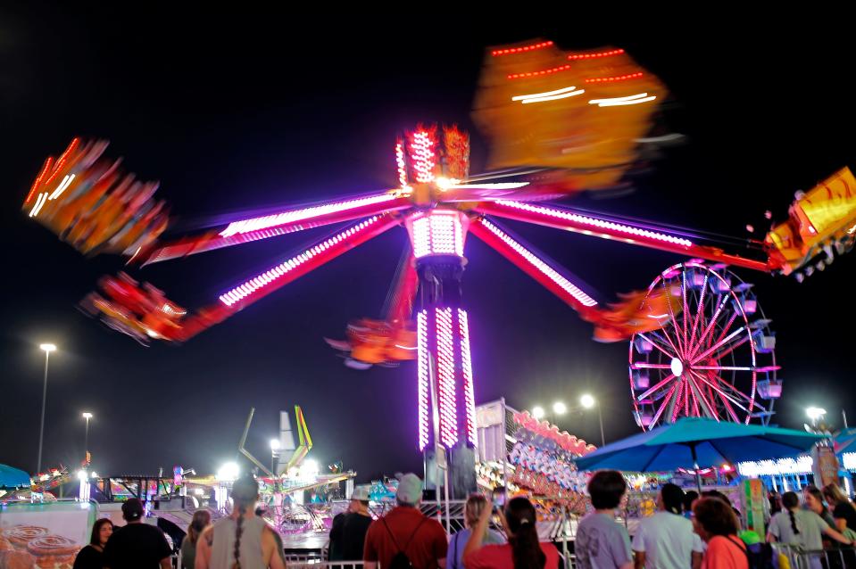 People look at a ride while waiting in line at the Oklahoma State Fair in Oklahoma City, Saturday, Sept. 16, 2023.