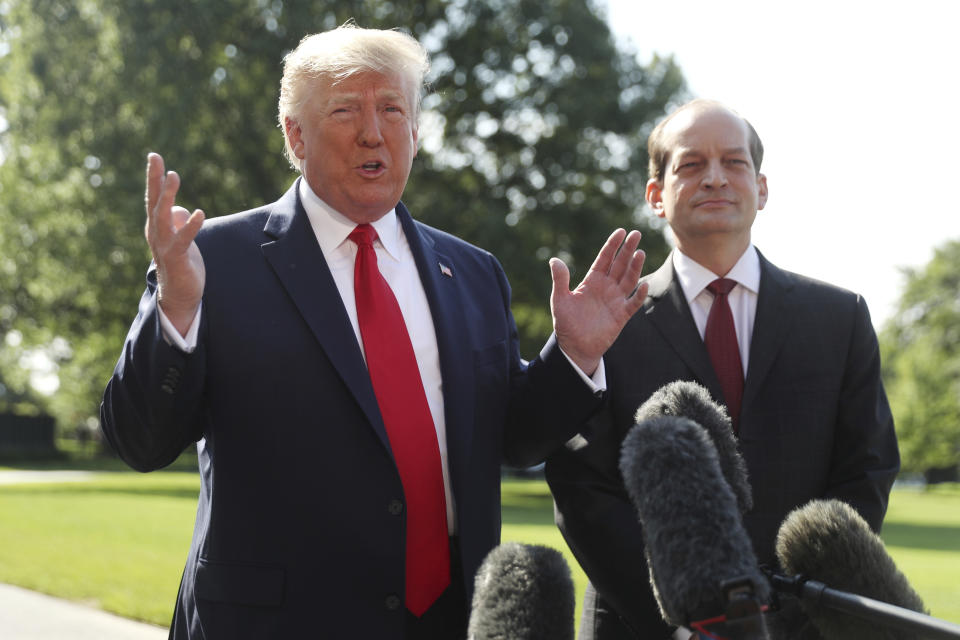 President Donald Trump speaks to members of the media with Secretary of Labor Alex Acosta on the South Lawn of the White House, Friday, July 12, 2019, before Trump boards Marine One for a short trip to Andrews Air Force Base, Md. and then on to Wisconsin. (AP Photo/Andrew Harnik)