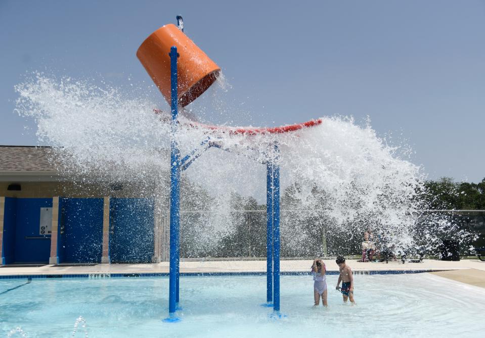 Nine-year-old Anastasia Olson, left, and her eight-year-old  brother Mark Anthony Olson Jr prepare to be splashed, Saturday, July 4, 2020, at Collier Pool. Their family attended the pool during the holiday weekend. 