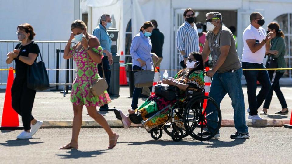 People leave the Miami Dade College North vaccination site where the second dose of the Pfizer-BioNTech COVID-19 vaccine is available in Miami on Tuesday, April 13, 2021.