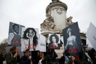 Demonstrators hold placards depicting famous women on Place de la Republique in Paris on March 8, 2018 during a demonstration to mark International Women's Day