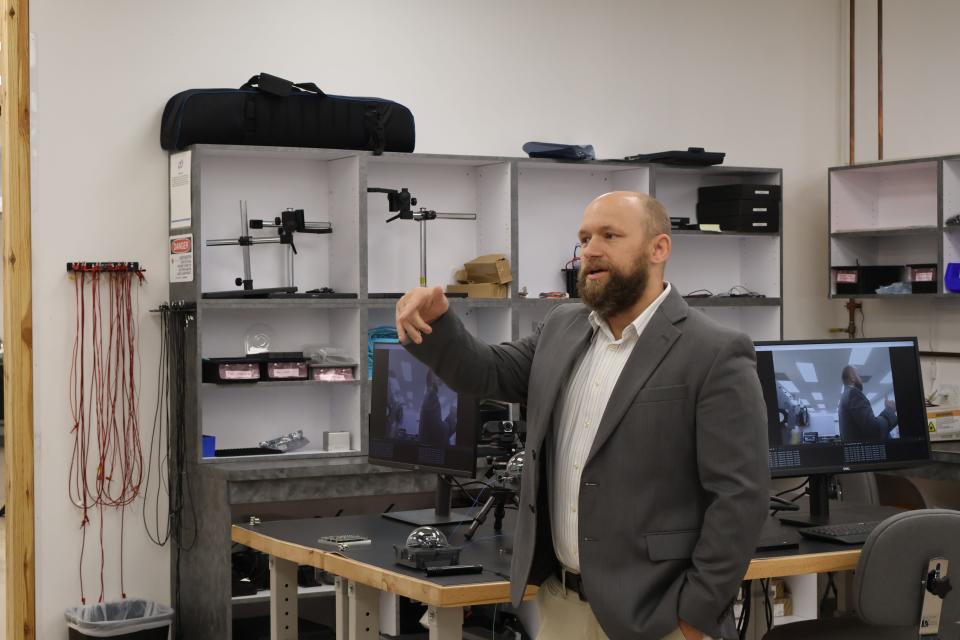 Micah Jenkins, Critical Frequency Design chief engineer of optics, discusses laser communications on the battlefield during a tour of his company's new Melbourne headquarters.