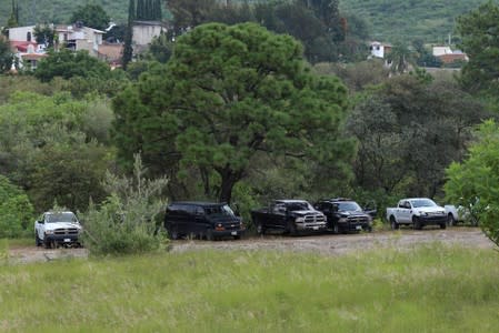 Vehicles from different corporations are parked near a clandestine grave while officials resumed the search for human remains after authorities found bodies packed in plastic bags, in the municipality of Zapopan