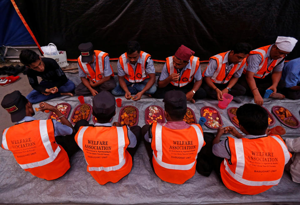 Security guards eat Iftar (breaking fast) meals at a railway platform during the holy fasting month of Ramadan, in Kolkata, India June 14, 2017. REUTERS/Rupak De Chowdhuri