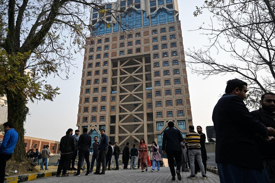 People gather outside a building in the aftermath of an earthquake in Islamabad on January 11, 2024.