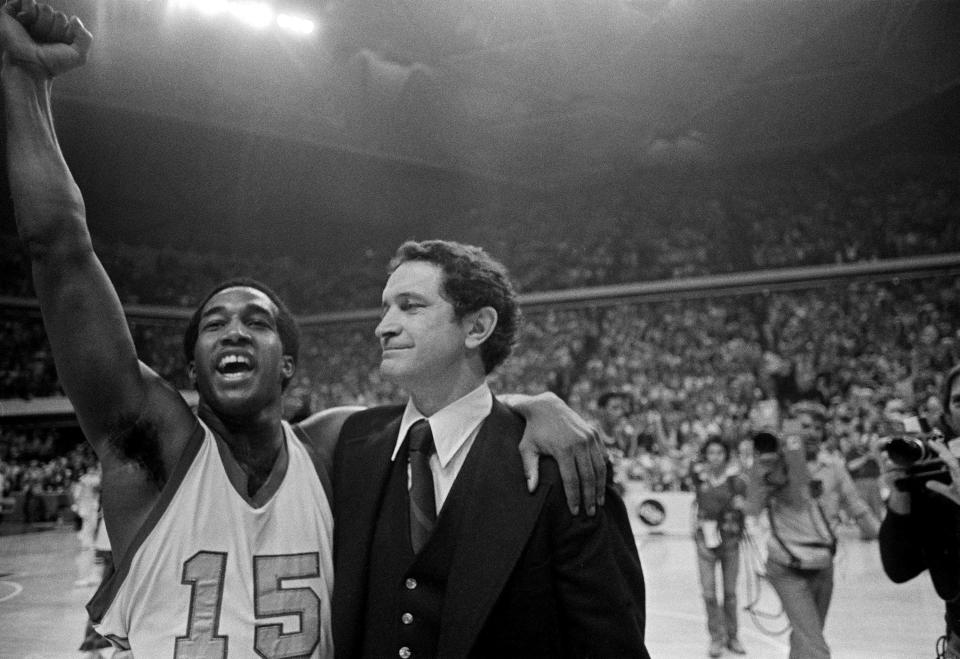 FILE - Marquette player Butch Lee, left, and coach Al McGuire smile after the Marquette team won over The University of North Carolina at Charlotte in the NCAA college basketball semifinals in Atlanta, March 26, 1977. Marquette won 51-49 with a last-second shot. (AP Photo/File)