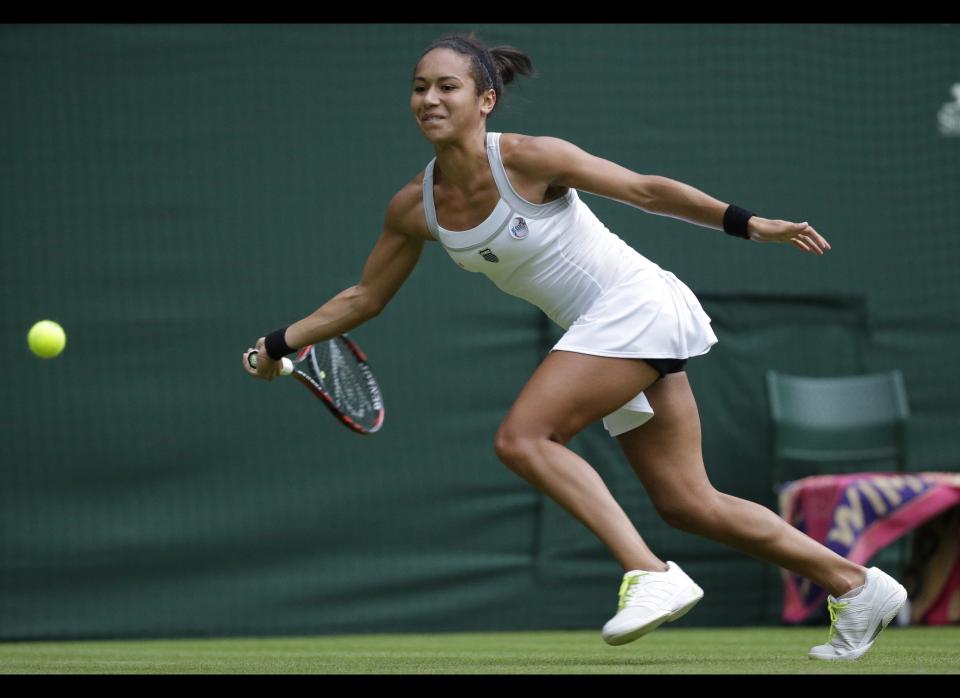 Heather Watson of Britain plays a return during a first round women's singles match against Iveta Benesova of the Czech Republic at the All England Lawn Tennis Championships at Wimbledon, England, Monday, June 25, 2012.