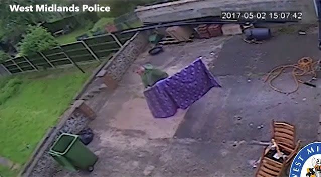 He hangs up the blanket on the clothesline two weeks after seen on CCTV walking into his room with it. Source: West Midlands Police