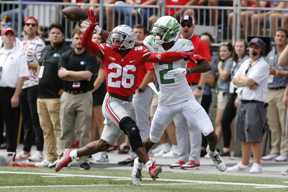 Ohio State defensive back Cameron Brown, left, knocks the ball away from Oregon receiver Devon Williams during the first half of an NCAA college football game Saturday, Sept. 11, 2021, in Columbus, Ohio. (AP Photo/Jay LaPrete)