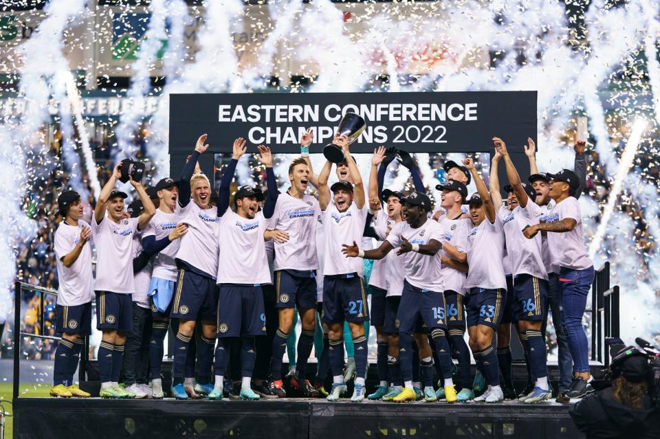 FILE -Philadelphia Union's Kai Wagner, center, lifts the trophy as the Philadelphia Union celebrates the win following the MLS soccer match against New York City FC, Sunday, Oct. 30, 2022, in Chester, Pa. The push toward the World Cup in 2026 begins now for Major League Soccer. The league, entering its 28th season this year, has a new team in St. Louis City and a new media deal with Apple TV. This season will also feature an expanded Leagues Cup, which will involve all of the MLS and Liga MX teams for the first time. (AP Photo/Chris Szagola, File)