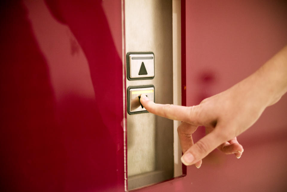 Business women pressing elevator button. finger presses the elevator button.  lift. high floor.hand reaches for the button of the elevator call.touching going up sign lift control panel