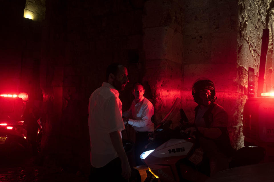 Paramedics on motorbikes who responded to a shooting attack that wounded several Israelis near the Old City of Jerusalem, early Sunday, Aug. 14, 2022. Israeli police and medics say a gunman opened fire at a bus in a suspected Palestinian attack that came a week after violence flared up between Israel and militants in Gaza. (AP Photo/ Maya Alleruzzo)