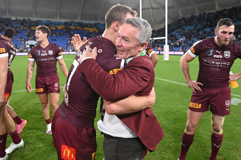 Seen here, Maroons captain Daly Cherry-Evans and coach Paul Green hug after Origin Game III. 