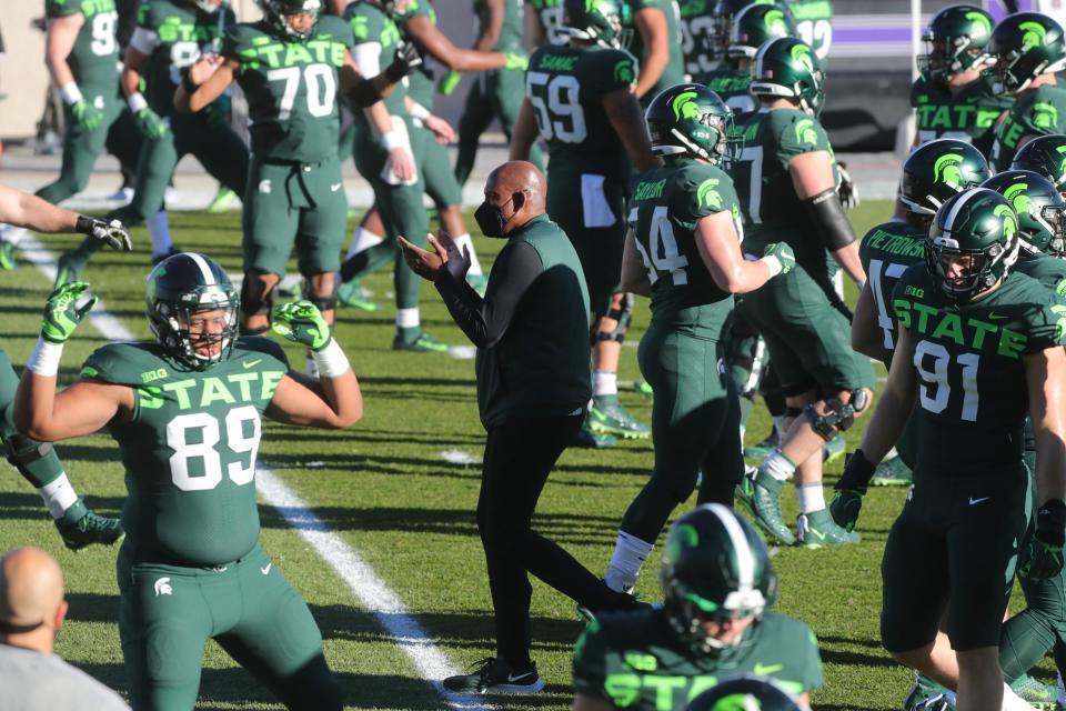 Michigan State coach Mel Tucker watches warmups before the game against Northwestern at Spartan Stadium Saturday, Nov. 28, 2020.