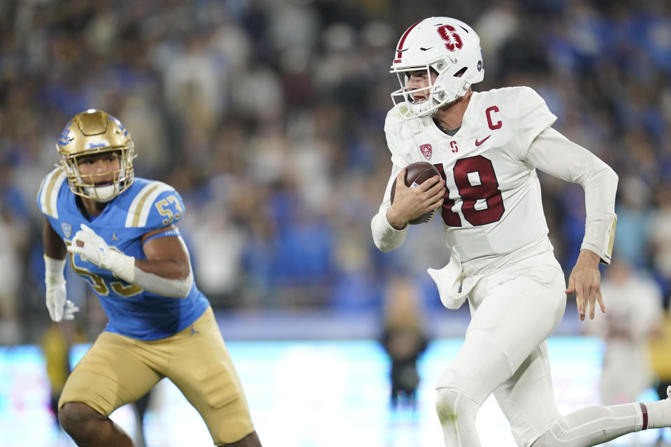 Stanford quarterback Tanner McKee (18) is threatened by UCLA linebacker Darius Muasau (53) during the first half of an NCAA college football game in Pasadena, Calif., Saturday, Oct. 29, 2022. (AP Photo/Ashley Landis)