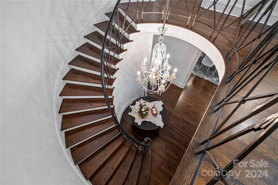 A spiral staircase leads to the second floor of the mansion.