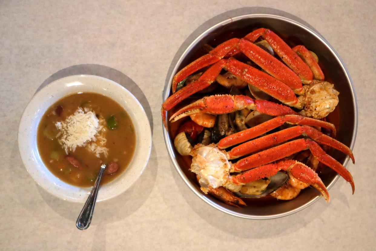 A bowl of jumbo, left, and a small platter of the seafood boil at Crafty Crab Thursday, Aug. 1, 2019. The platter serves two, packed with snow crab, muscles, clams, crawfish, and shrimp.