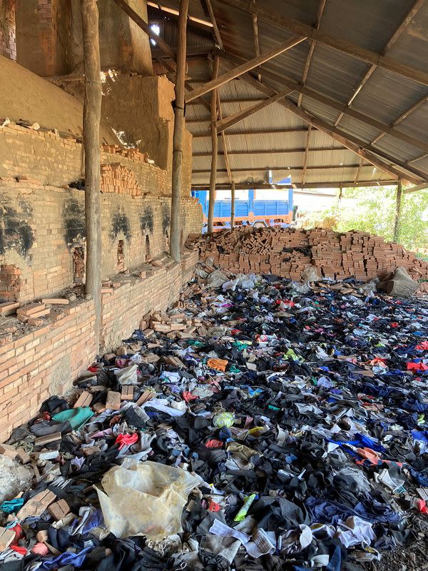 Waste from international clothing brands is stored before being used to fuel kilns at a brick factory on the outskirts of Phnom Penh