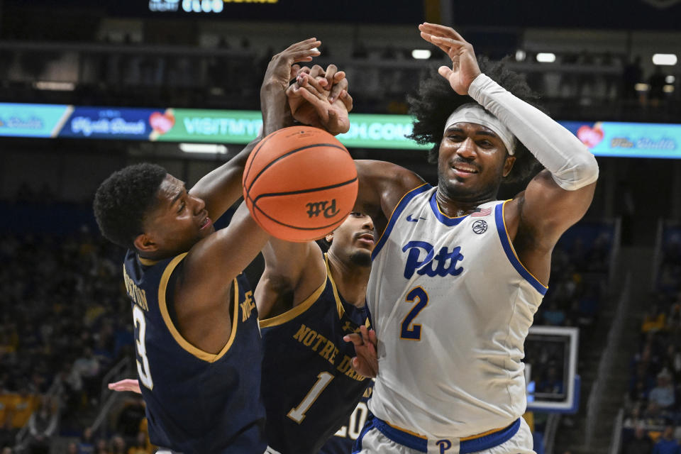 Pittsburgh forward Blake Hinson (2) battles Notre Dame guard Markus Burton (3) for a rebound during the second half of an NCAA college basketball game, Saturday, Feb. 3, 2024, in Pittsburgh. (AP Photo/Barry Reeger)