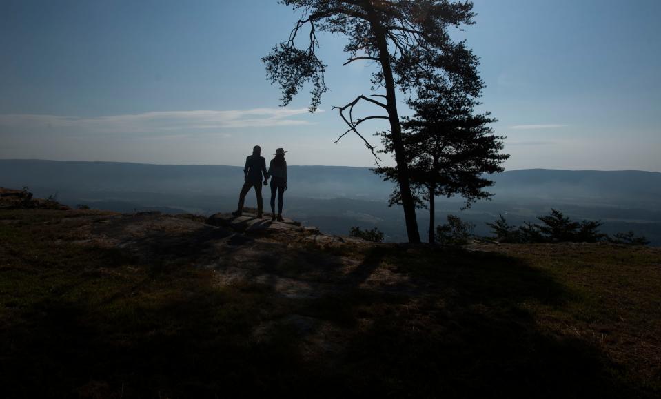 Bolt Farm Treehouse owners Seth and Tori Bolt take in the view from their cabins atop Whitwell Mountain in Whitwell, Tennessee on Sep 22, 2022. They have recently added mirrored cabins to their 55-acre nature retreat. The mirrored cabins are the first of their kind in the United States. 