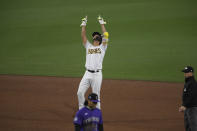 San Diego Padres' Yu Darvish stands on second base as he points skyward after hitting a double during the sixth inning of a baseball game against the Colorado Rockies, Monday, May 17, 2021, in San Diego. (AP Photo/Denis Poroy)